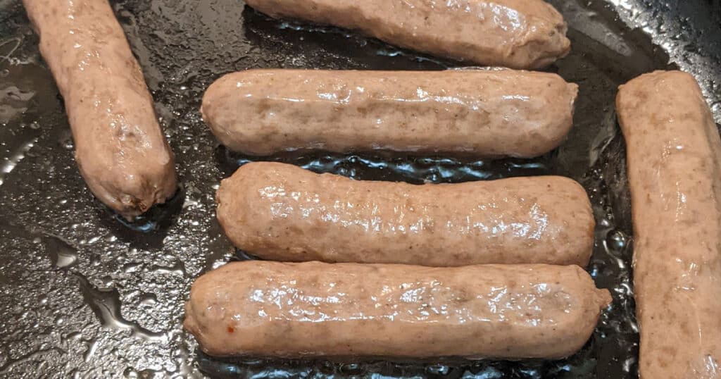 Beyond Breakfast Sausage fresh out of the package and cooking in a pan