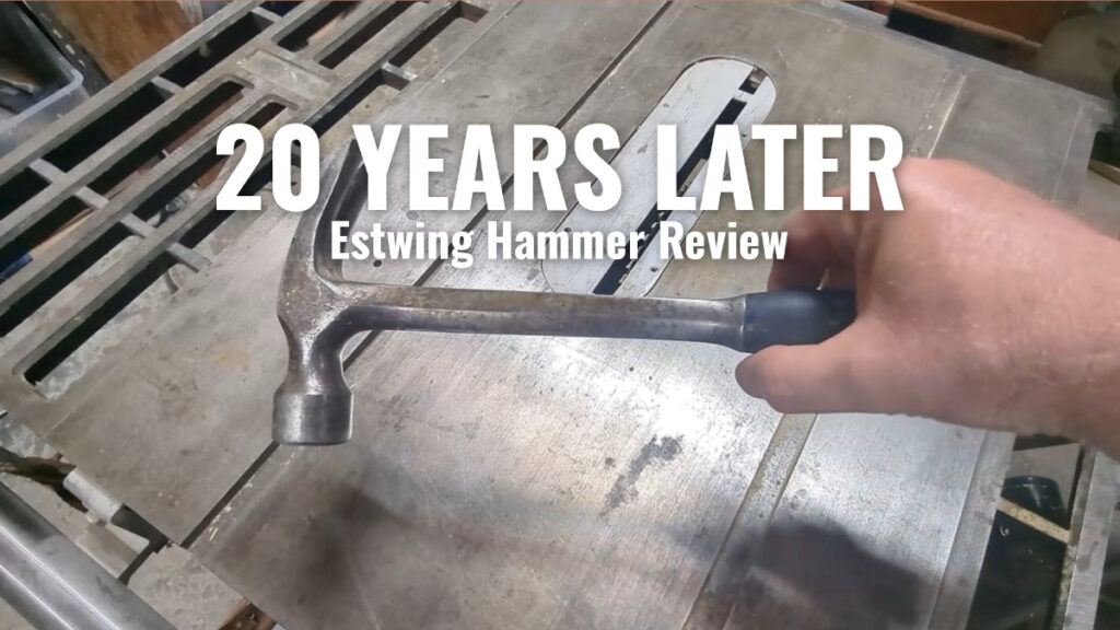 Estwing framing hammer after 20 years of use, held over a workbench – ITriedThat review